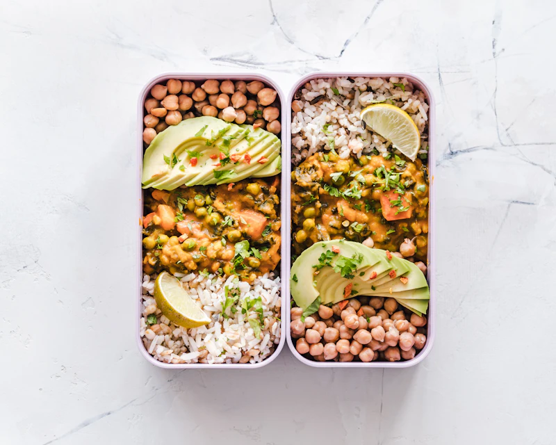 Meal-prep boxes with chickpeas, vegetables and avocado
