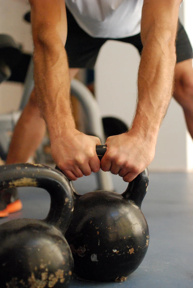 Hands gripping a kettlebell before a set